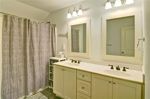 a bathroom with a double vanity sink and a mirror