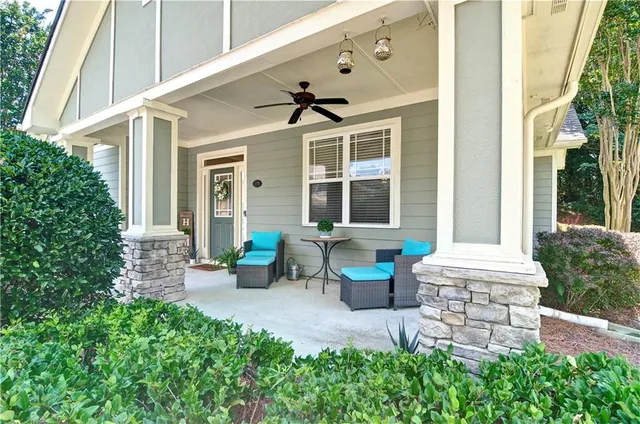 a front view of a house with porch and garden