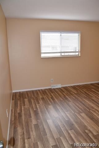 1225 South Oneida Street, Unit 252 Denver, CO 80224 - Photo 14 of 20 a view of a room with wooden floor and windows