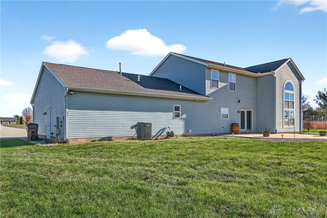 6560 Snyder Road Fletcher, OH 45326 - Photo 51 of 71 This residence features durable vinyl siding and a charming patio, perfect for outdoor enjoyment.