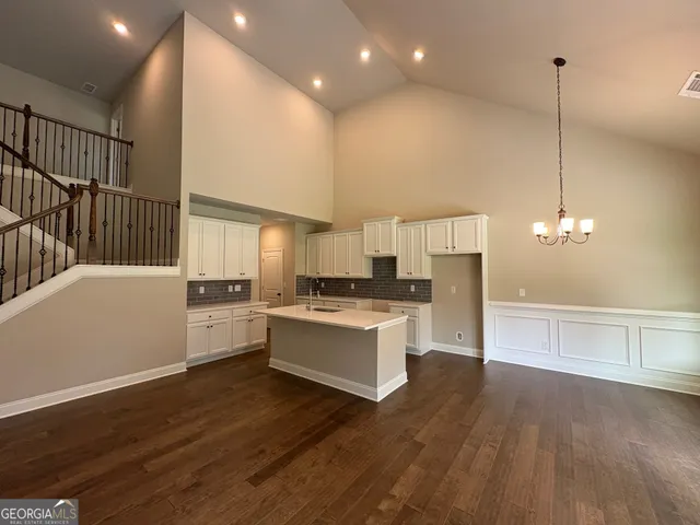 a kitchen with a sink cabinets and wooden floor