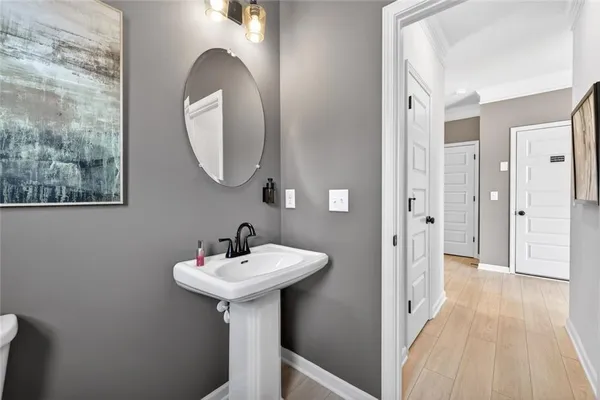 a bedroom with a bed and painting on the wall