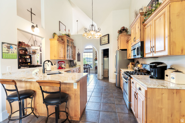 7343 North Sawtooth Cv Road Vernal, UT 84078 - Photo 8 of 64 Kitchen featuring alder cabinetry, granite countertops, stainless steel appliances, and tile flooring