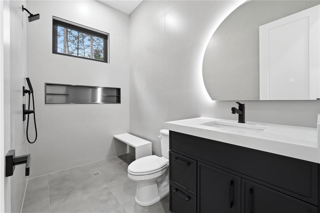 1563 Whitley Road Dacula, GA 30019 - Photo 35 of 44 a bathroom with a sink a toilet and shower
