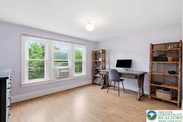 2021 Leithsville Road Hellertown, PA 18055 - Photo 23 of 39 Spacious and bright hobby room featuring polished wood flooring, offering a comfortable and adaptable space aside the primary bedroom.