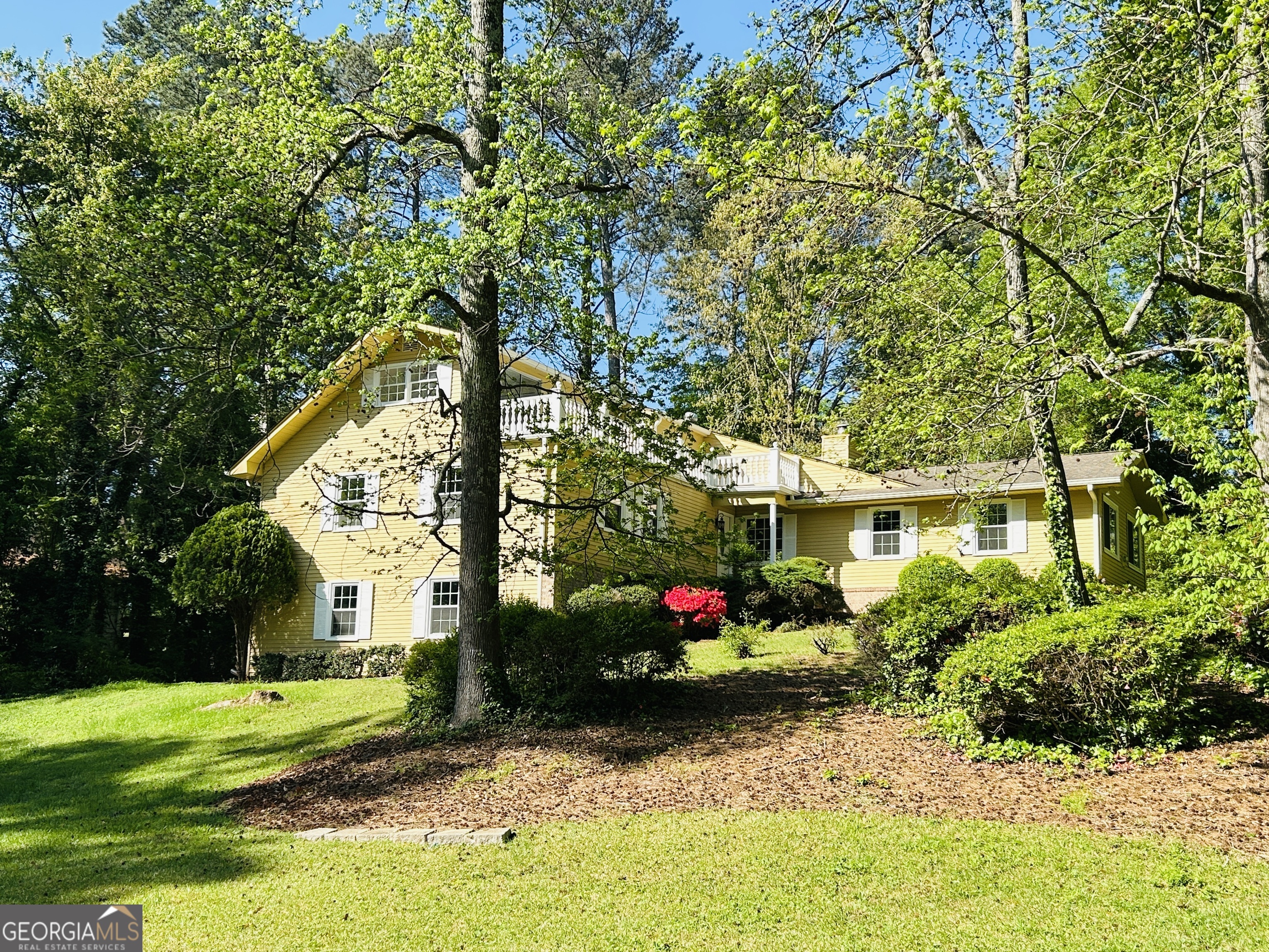 2131 Perrin Drive Lawrenceville, GA 30043 - Photo 1 of 60 a front view of a house with garden