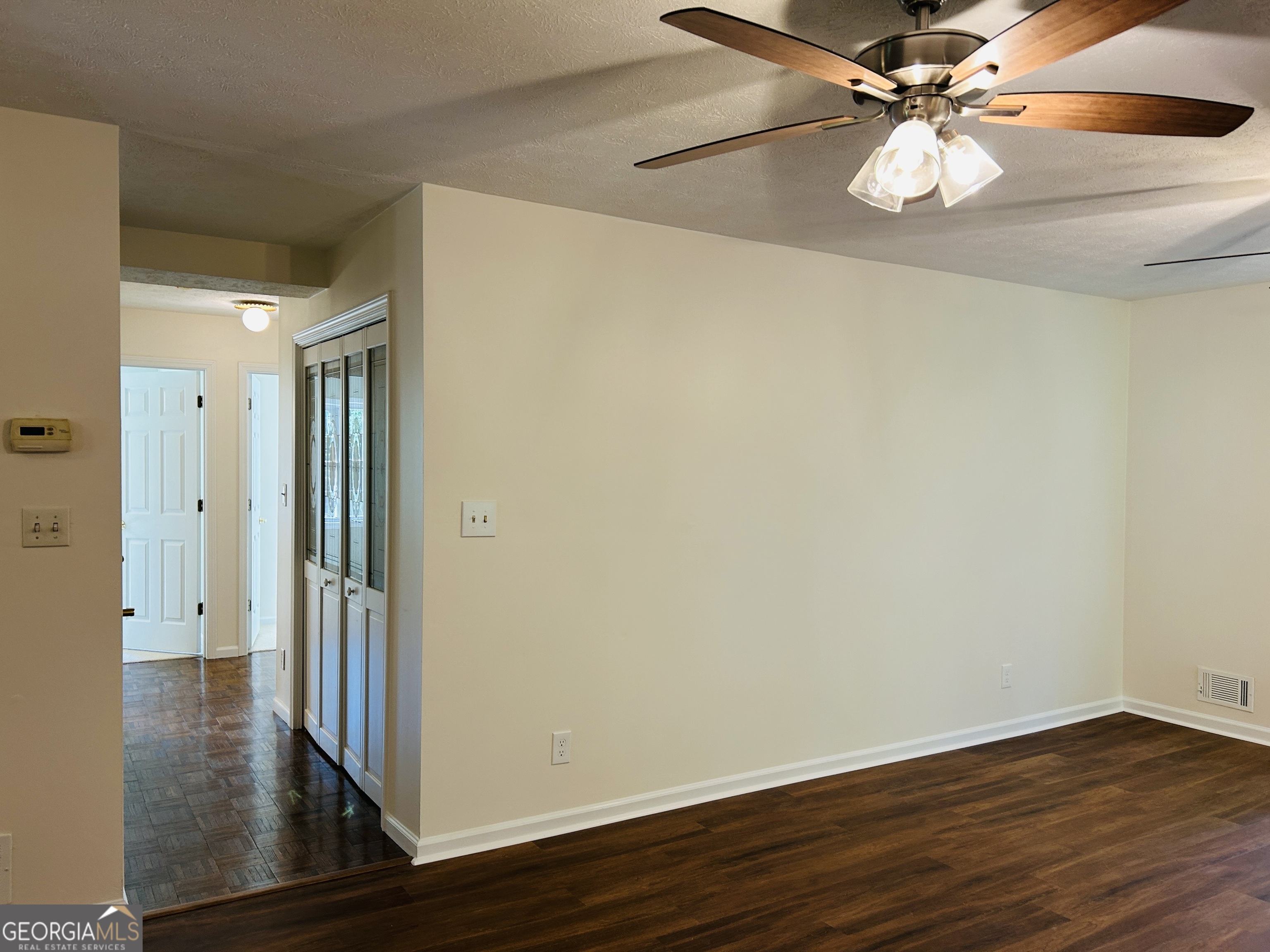 2131 Perrin Drive Lawrenceville, GA 30043 - Photo 12 of 60 an empty room with wooden floor and fan
