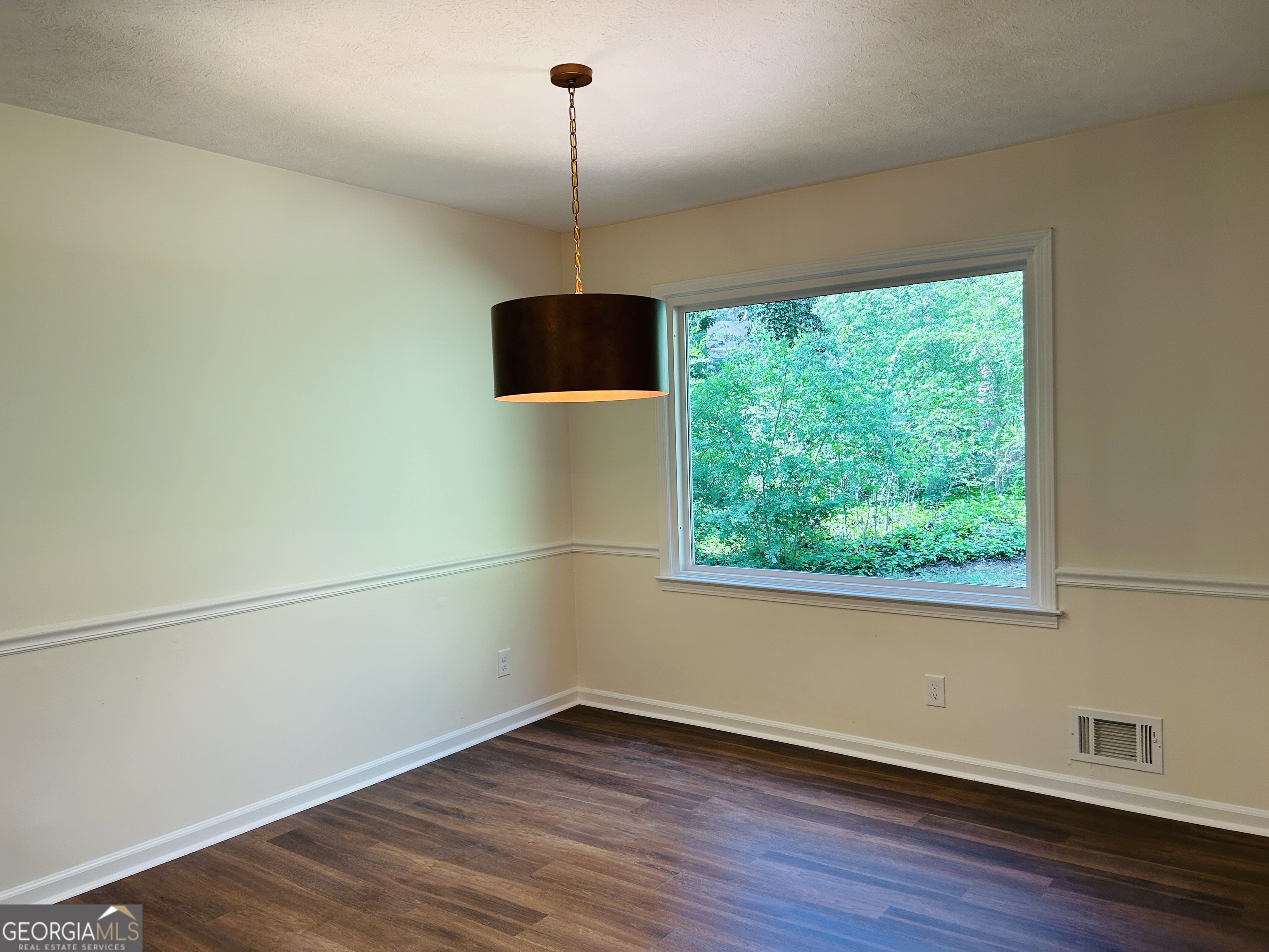 2131 Perrin Drive Lawrenceville, GA 30043 - Photo 13 of 60 a view of an empty room with wooden floor fridge and a window