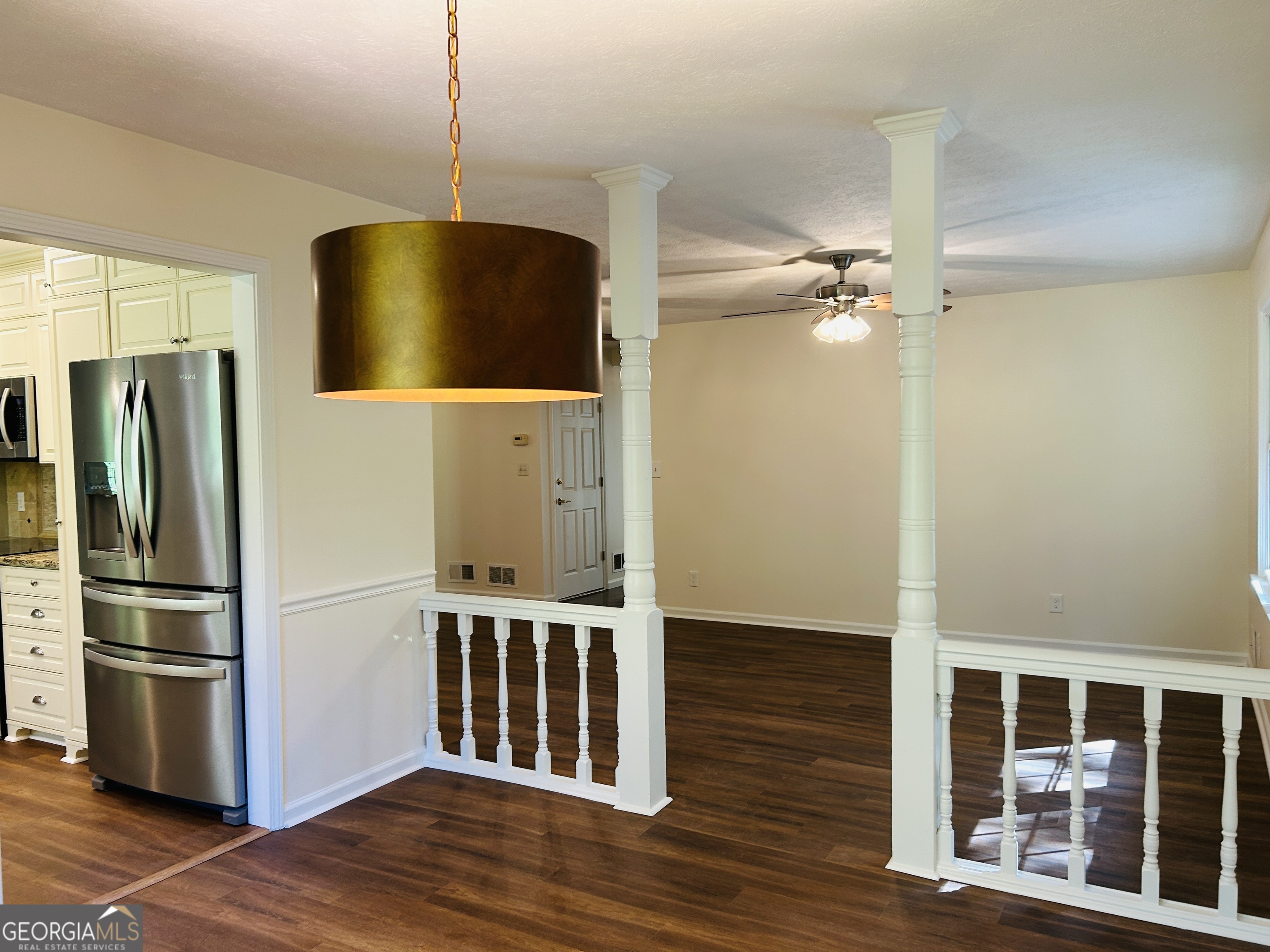 2131 Perrin Drive Lawrenceville, GA 30043 - Photo 15 of 60 a kitchen with stainless steel appliances a refrigerator and wooden floor