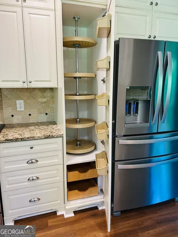 a kitchen with granite countertop a sink and a stove top oven