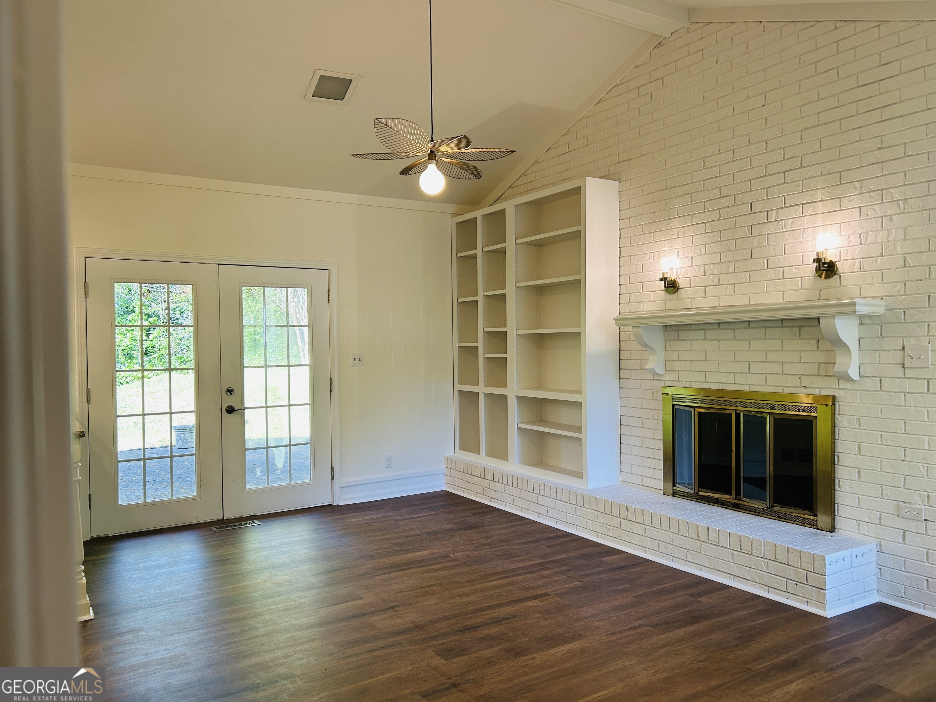 2131 Perrin Drive Lawrenceville, GA 30043 - Photo 25 of 60 an empty room with wooden floor fireplace and windows