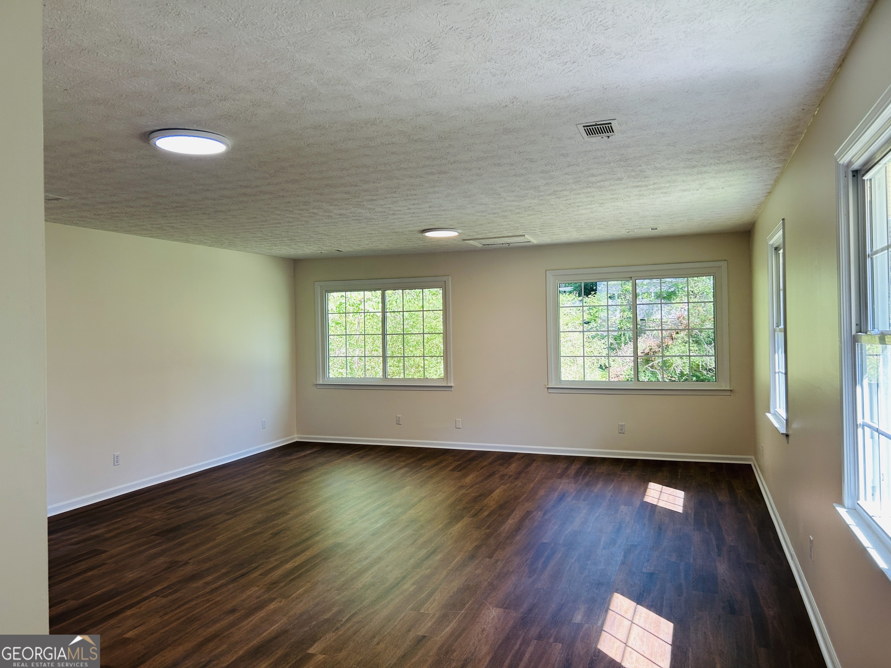 2131 Perrin Drive Lawrenceville, GA 30043 - Photo 29 of 60 an empty room with wooden floor and windows