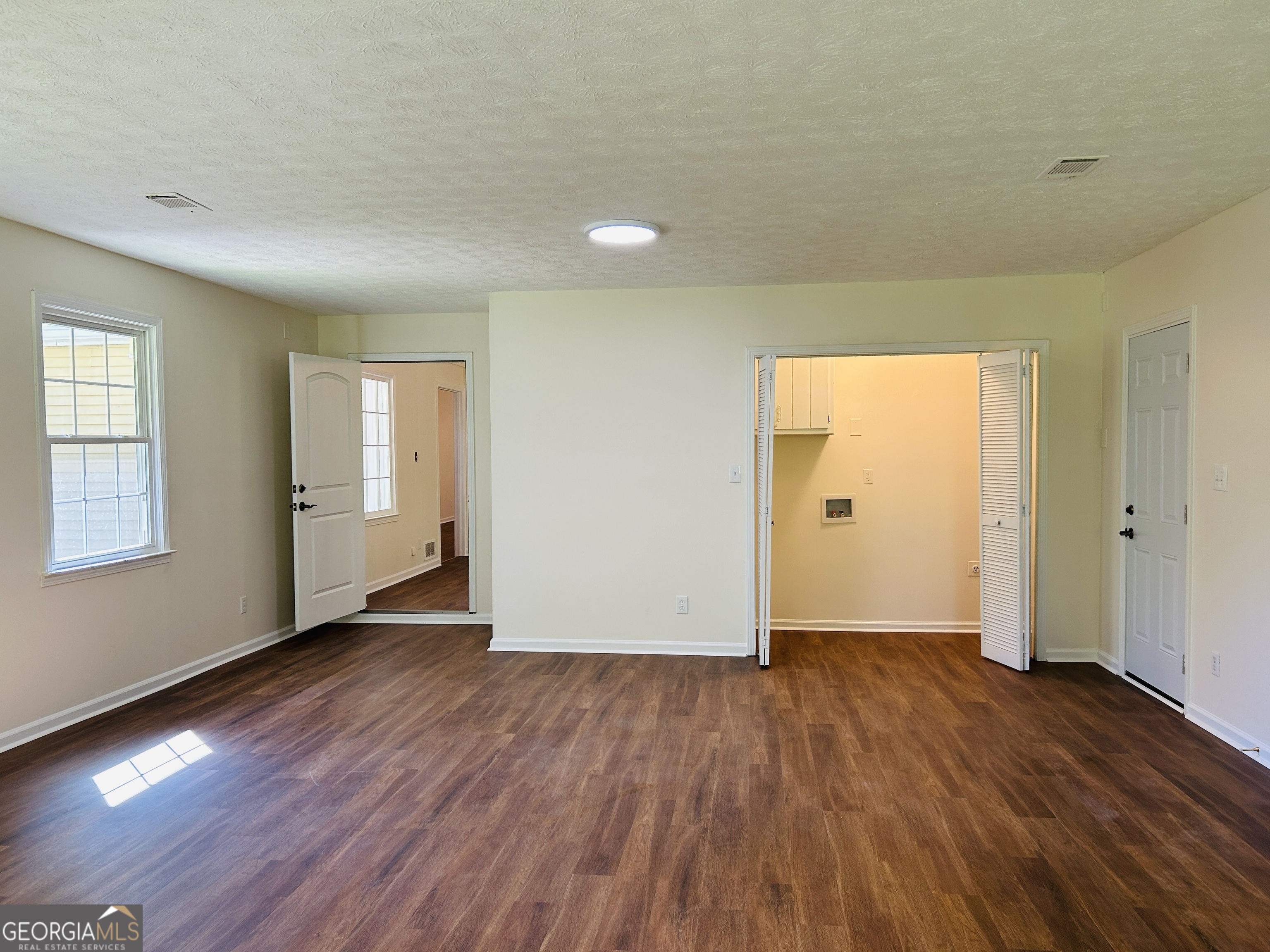 2131 Perrin Drive Lawrenceville, GA 30043 - Photo 30 of 60 an empty room with wooden floor and windows