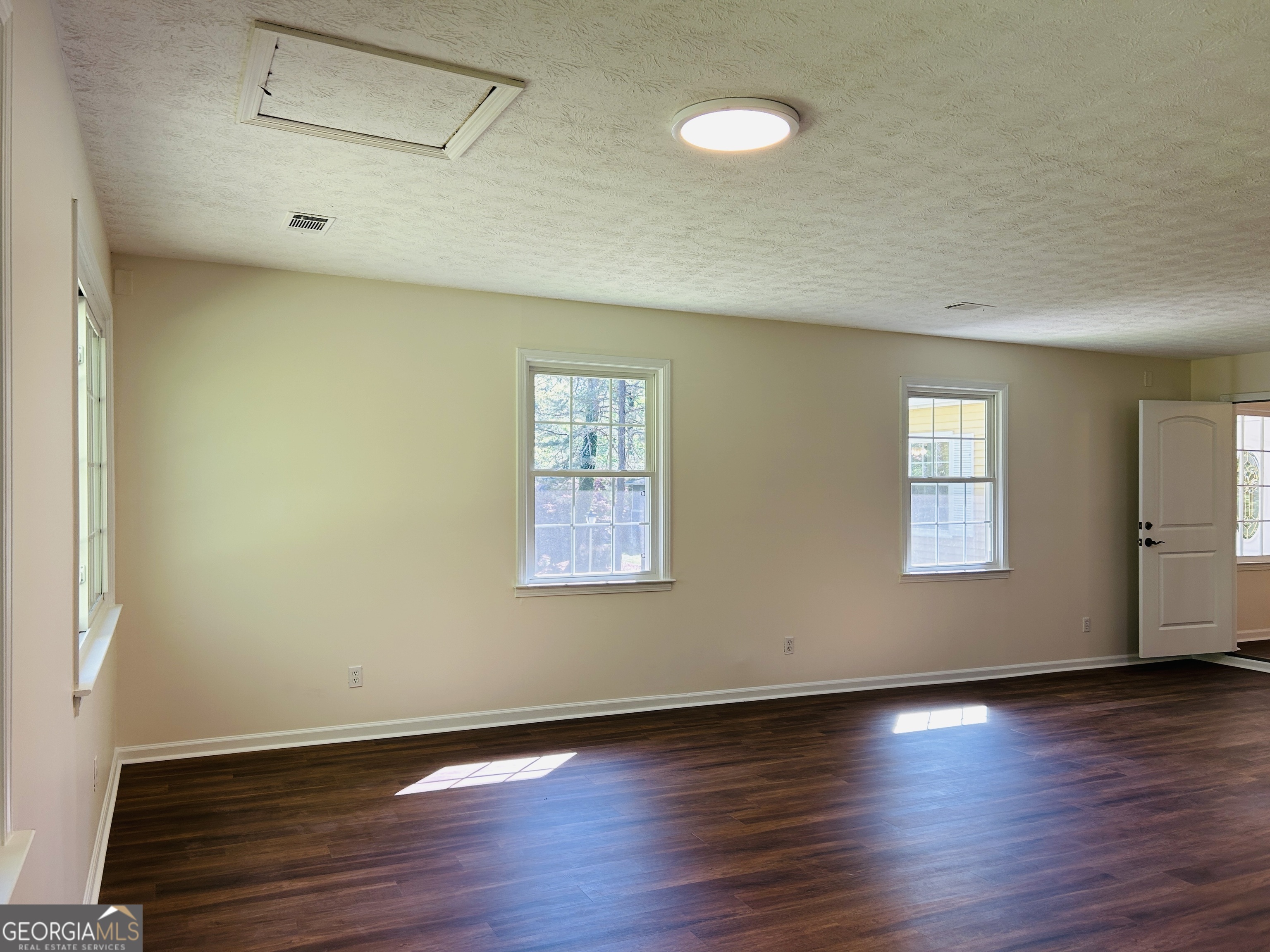 2131 Perrin Drive Lawrenceville, GA 30043 - Photo 31 of 60 a view of an empty room with wooden floor and a window