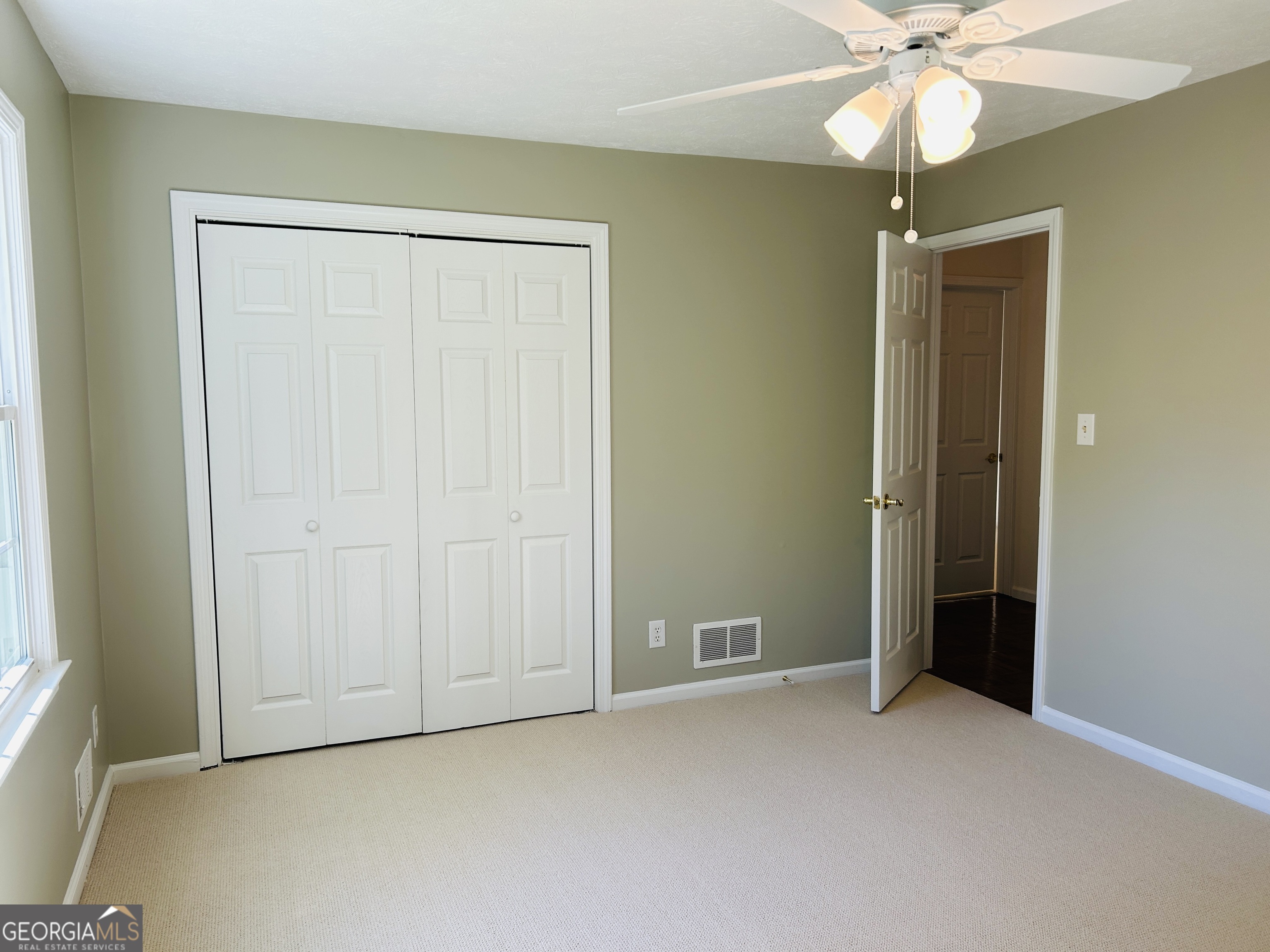 2131 Perrin Drive Lawrenceville, GA 30043 - Photo 43 of 60 an empty room with closet and a chandelier fan