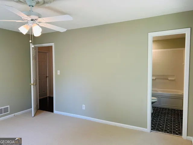 a bathroom with a white bath tub sitting next to a white sink and vanity
