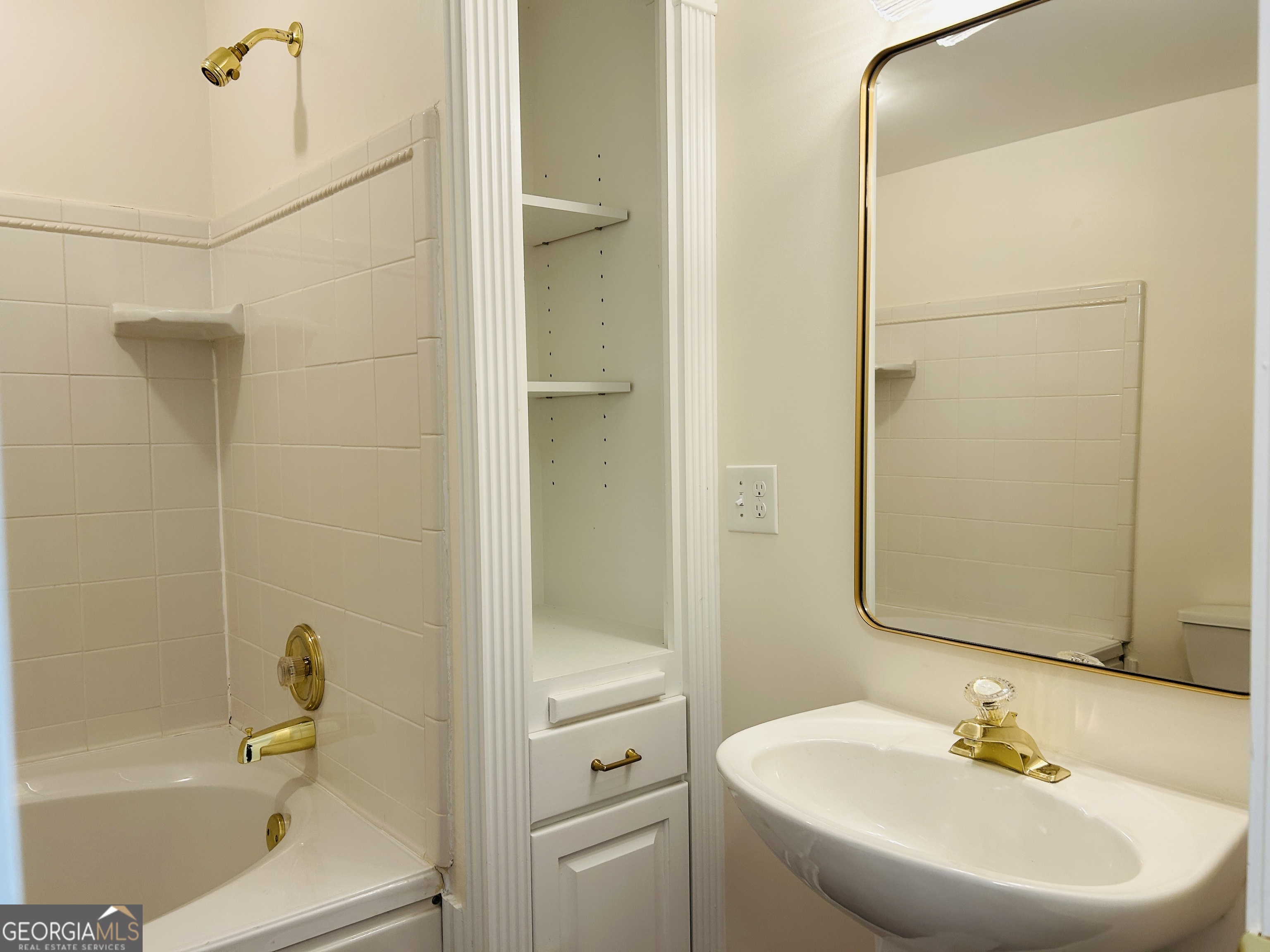 2131 Perrin Drive Lawrenceville, GA 30043 - Photo 51 of 60 a bathroom with a white bath tub sitting next to a white sink and vanity