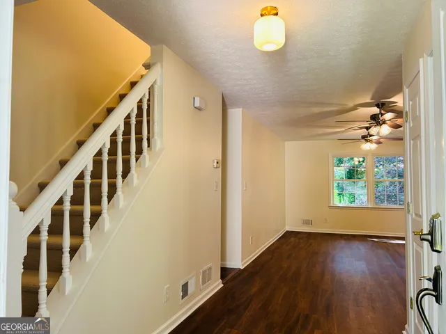 a view of an entryway with wooden floor