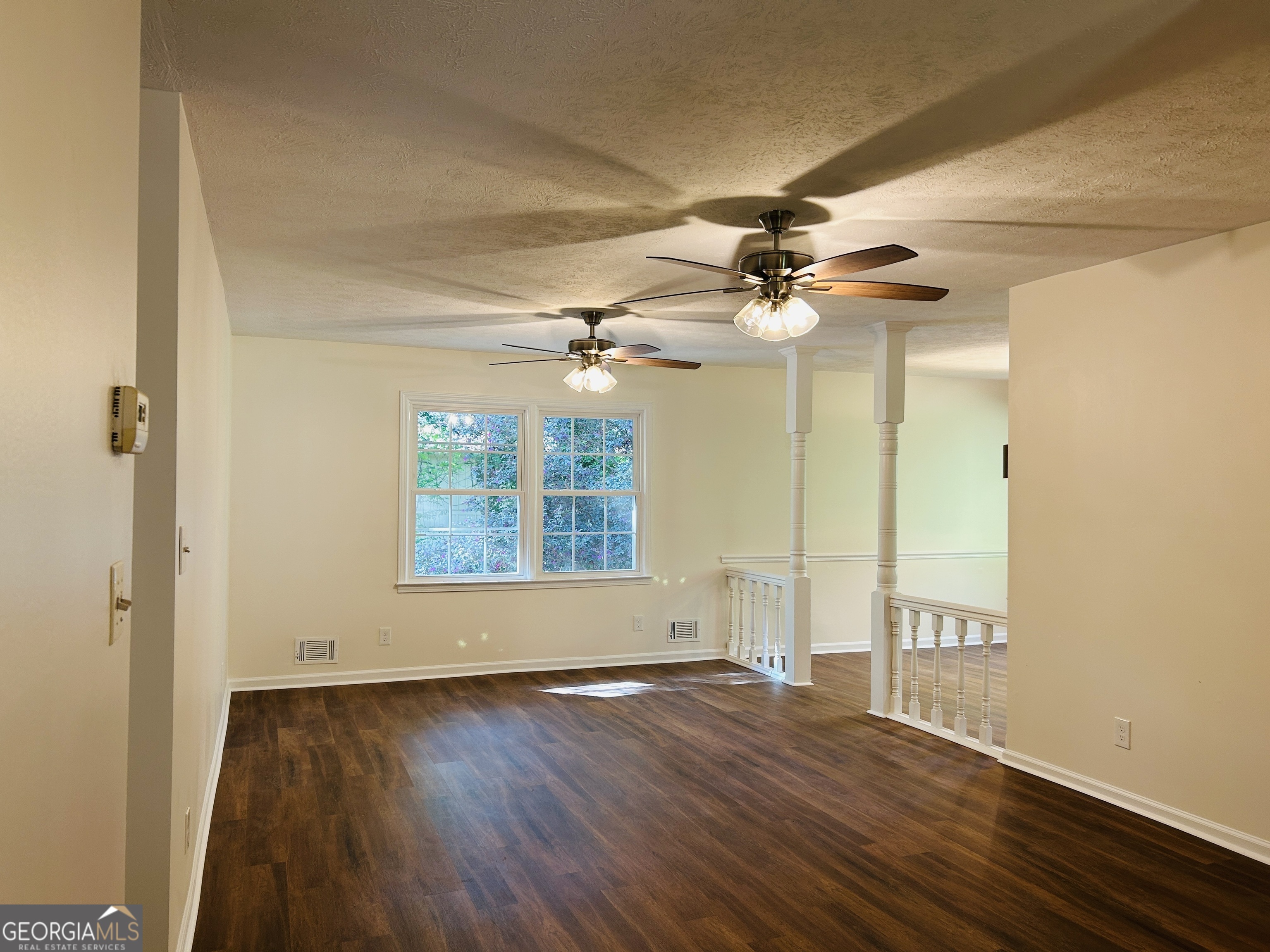 2131 Perrin Drive Lawrenceville, GA 30043 - Photo 8 of 60 an empty room with wooden floor fan and windows