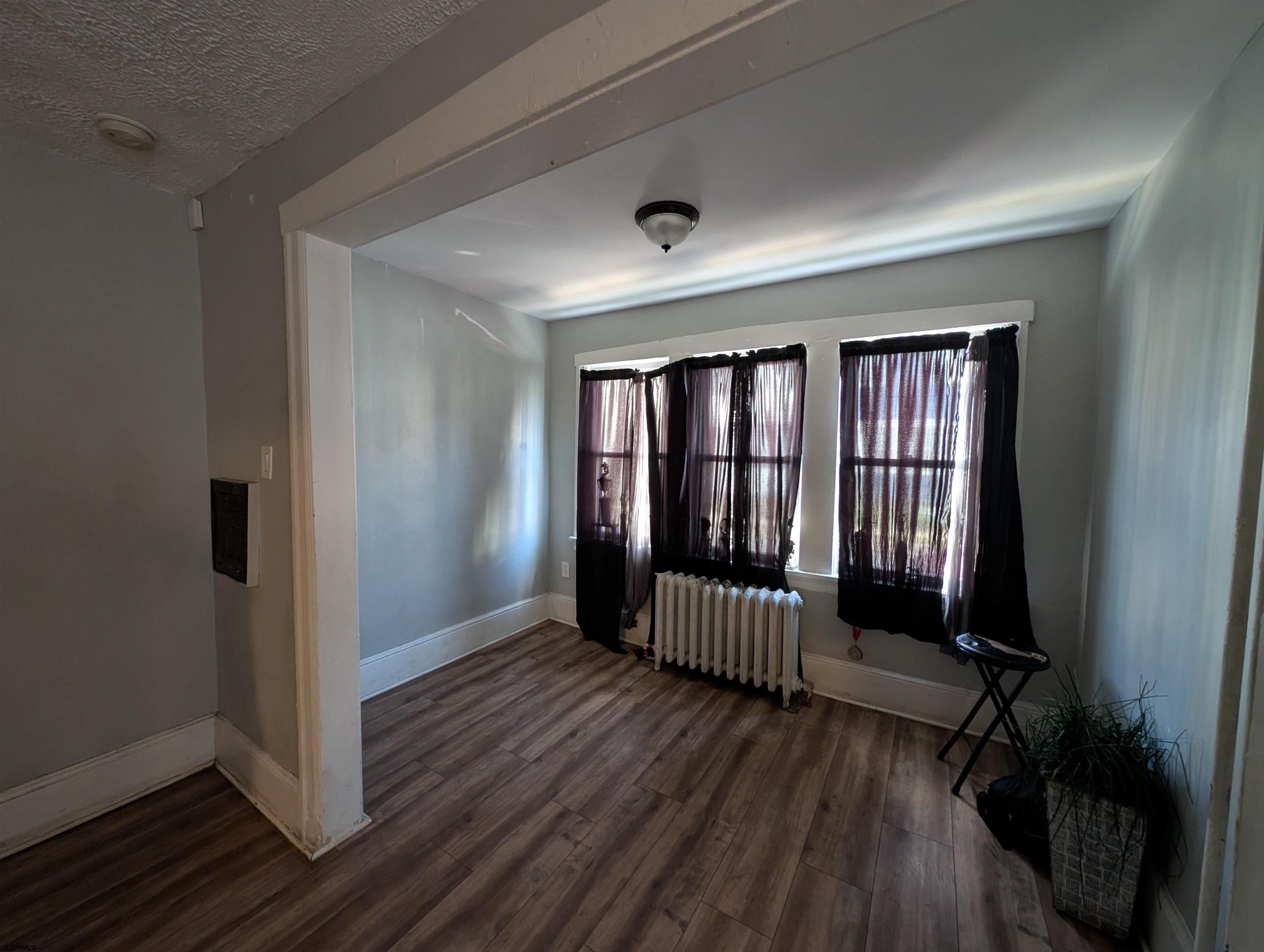 237 Guard Place Pleasantville, NJ 08232 - Photo 12 of 16 wooden floor in an empty room with a window