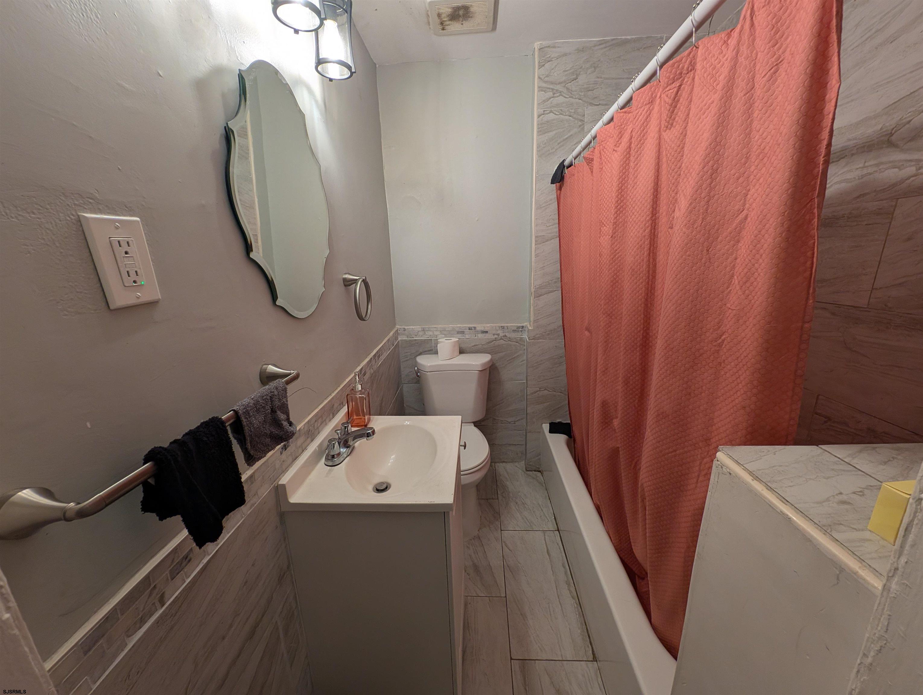 237 Guard Place Pleasantville, NJ 08232 - Photo 9 of 16 a bathroom with a sink and mirror with bathtub