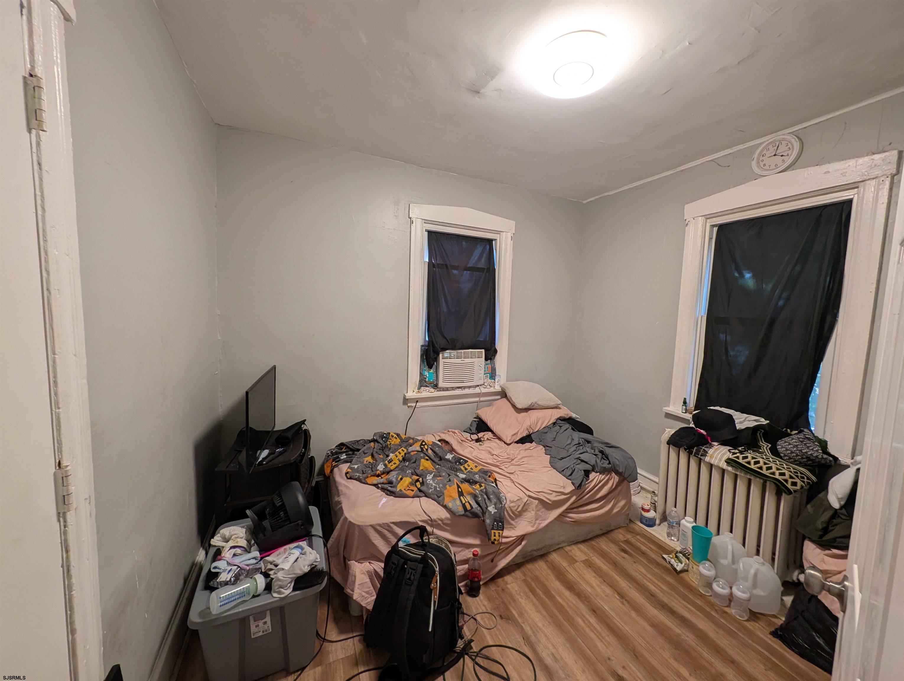 237 Guard Place Pleasantville, NJ 08232 - Photo 10 of 16 a bedroom with a bed and a flat tv screen