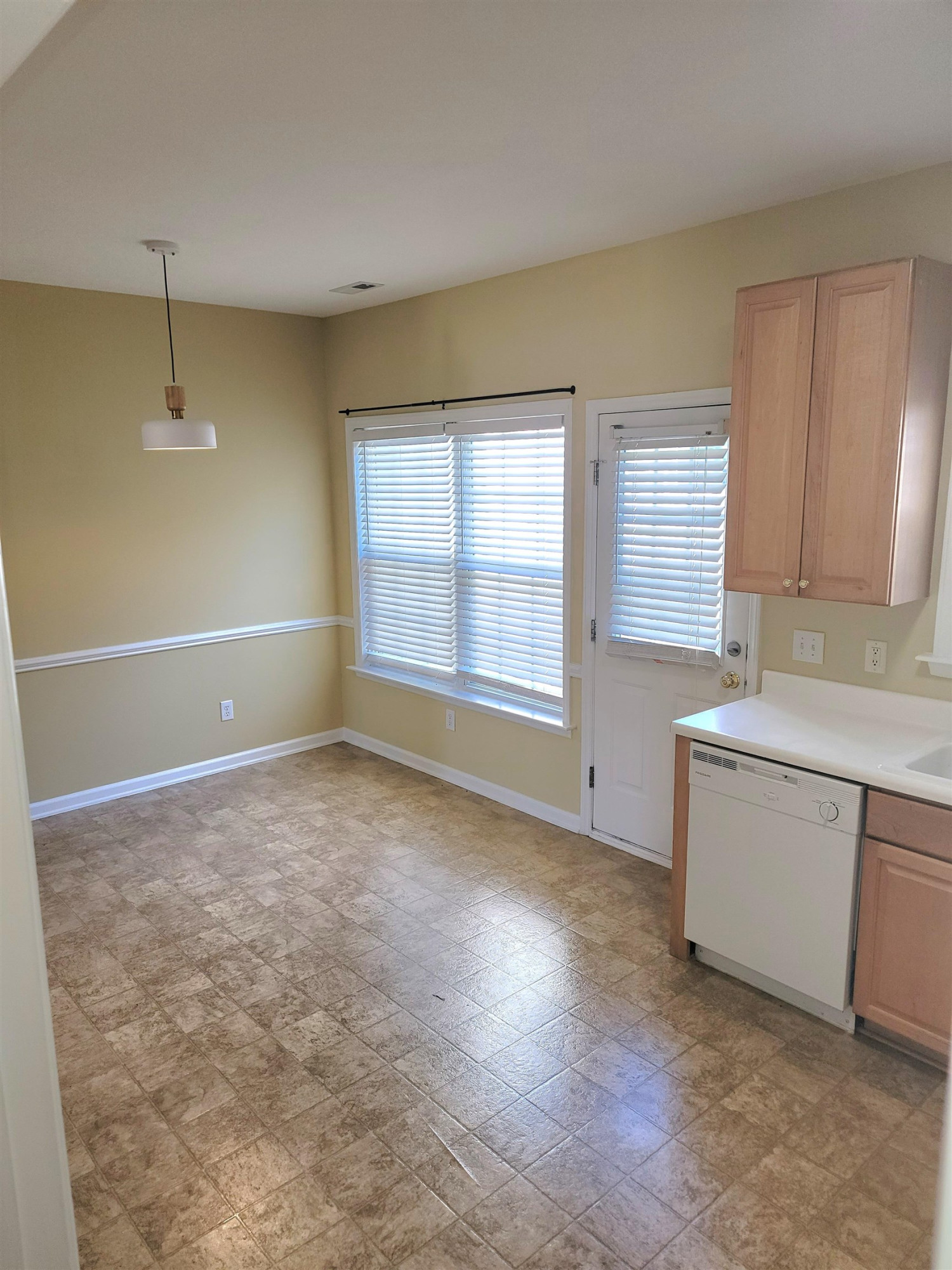 213 Dairy Road Clayton, NC 27520 - Photo 14 of 31 a view of an empty room with window and wooden floor