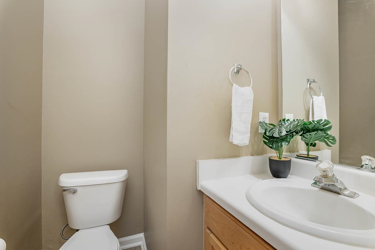 213 Dairy Road Clayton, NC 27520 - Photo 18 of 31 a bathroom with a sink a toilet and a mirror