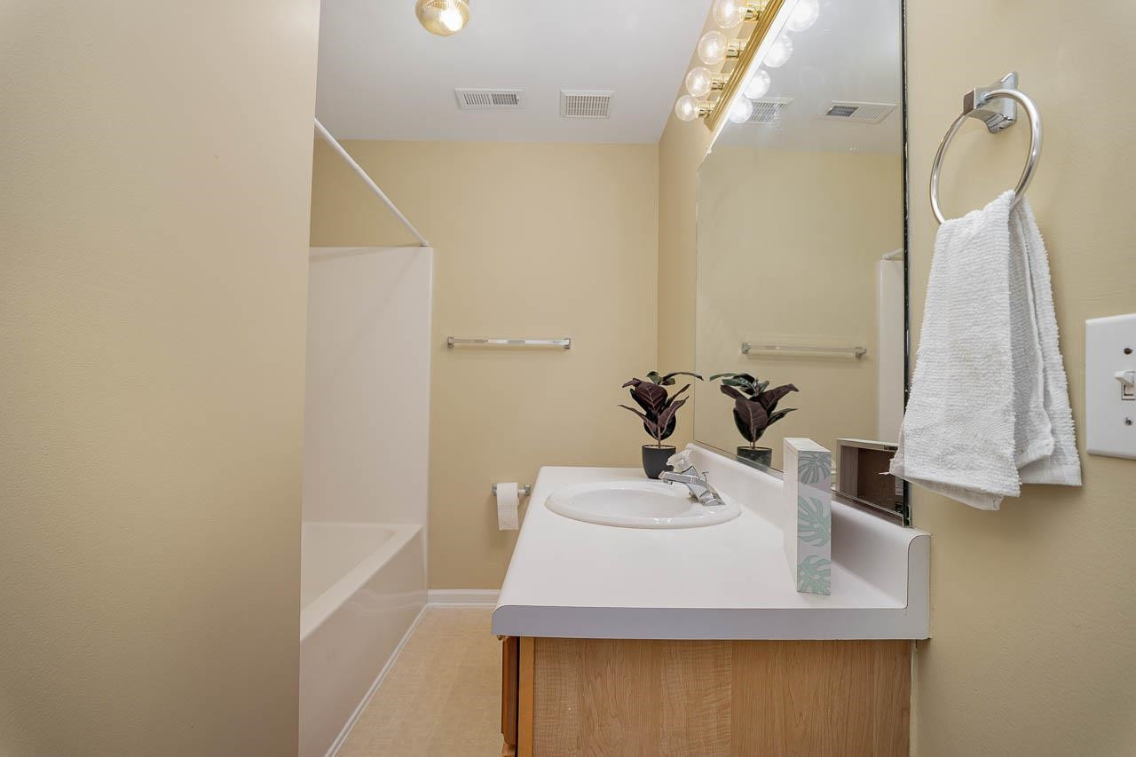 213 Dairy Road Clayton, NC 27520 - Photo 27 of 31 a bathroom with a sink a mirror and shower