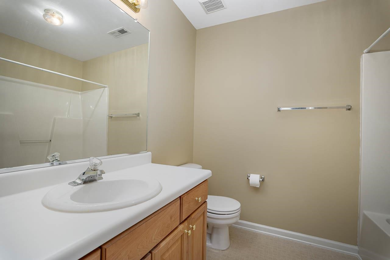 213 Dairy Road Clayton, NC 27520 - Photo 28 of 31 a bathroom with a sink toilet and a mirror