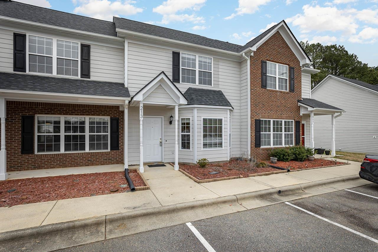 213 Dairy Road Clayton, NC 27520 - Photo 3 of 31 a front view of a house with a yard and a garage