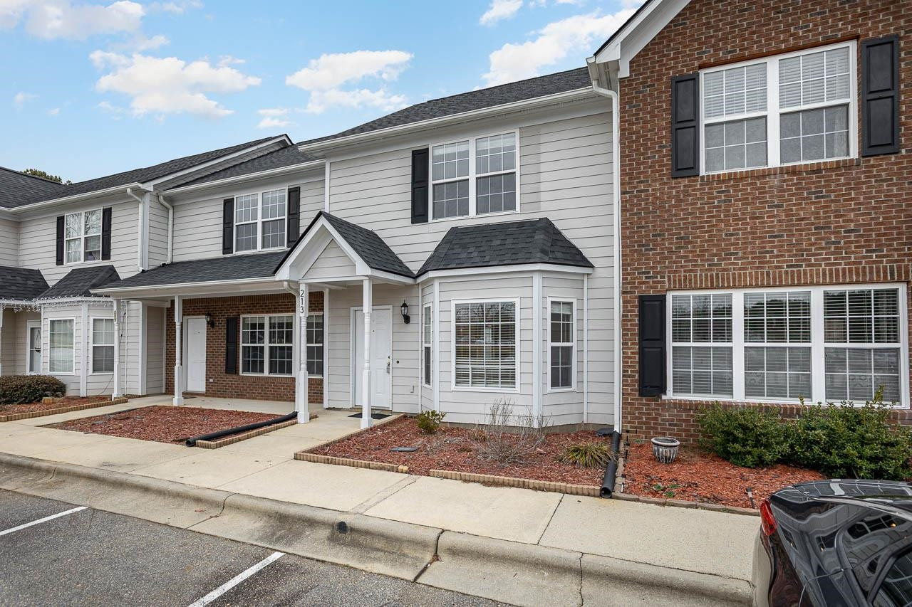 213 Dairy Road Clayton, NC 27520 - Photo 4 of 31 a front view of a house with a yard