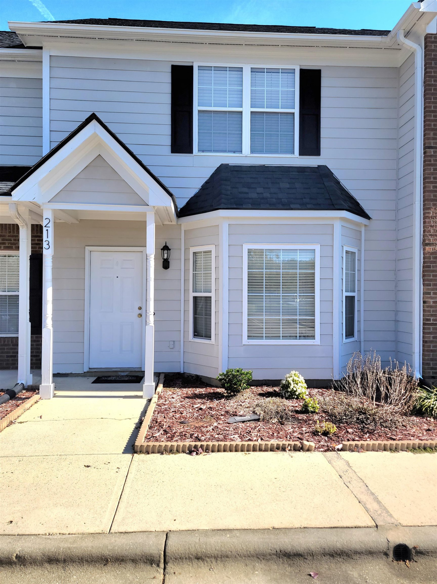 213 Dairy Road Clayton, NC 27520 - Photo 5 of 31 a front view of a house with a yard