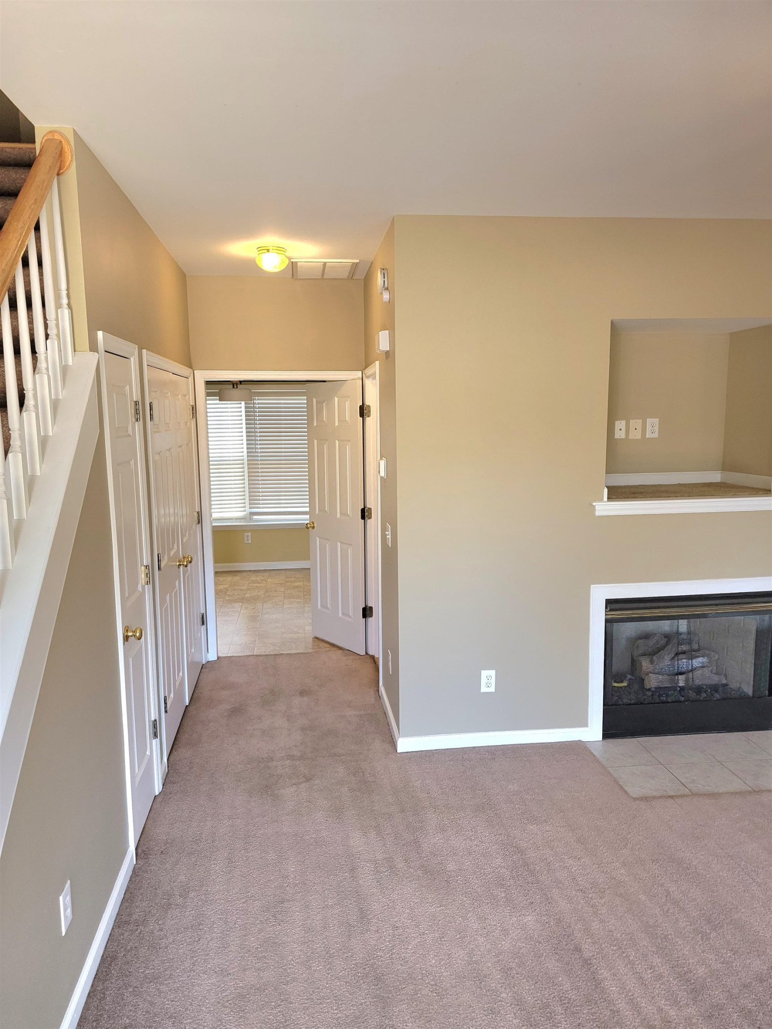 213 Dairy Road Clayton, NC 27520 - Photo 7 of 31 a view of a hallway with wooden floor and a fireplace