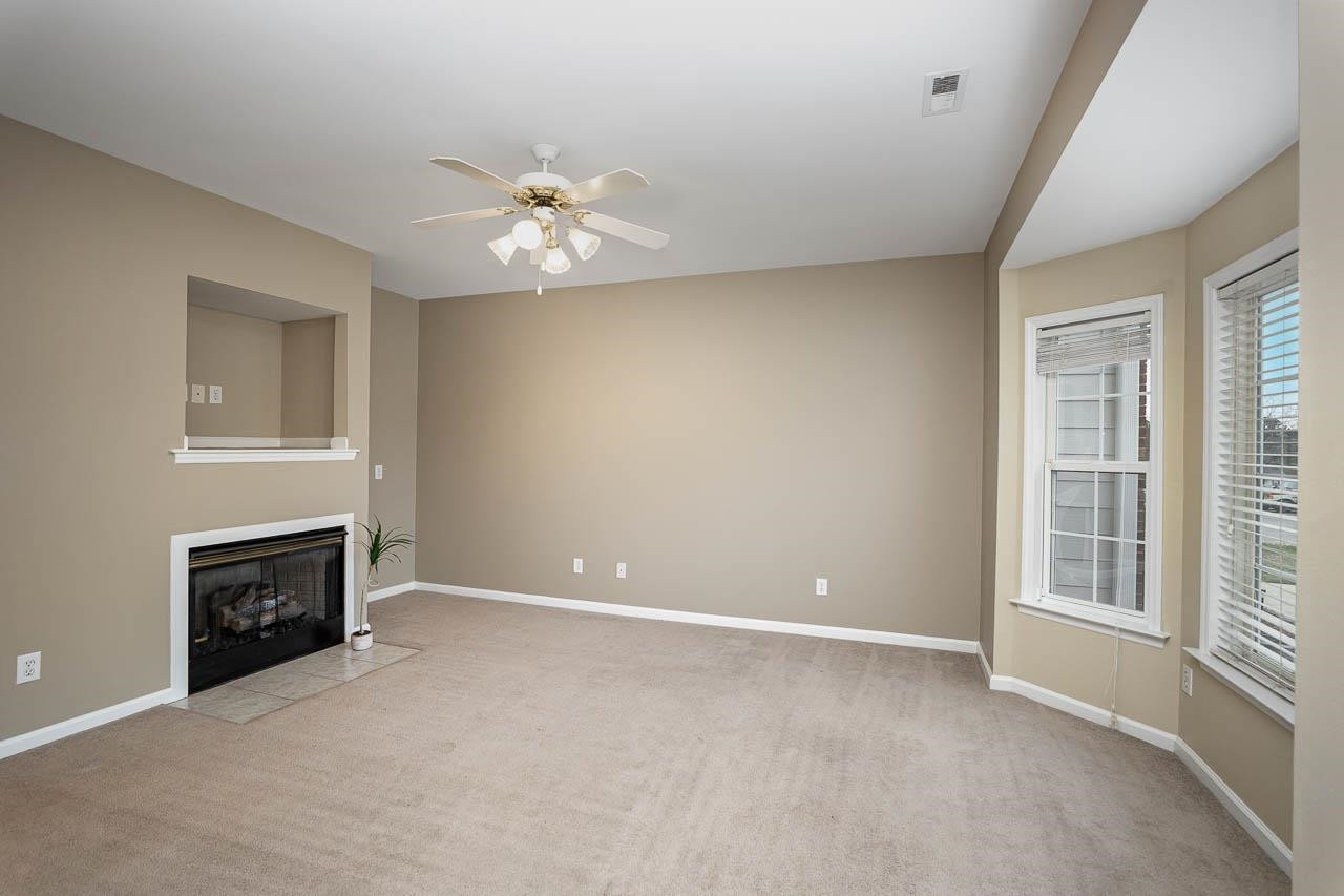 213 Dairy Road Clayton, NC 27520 - Photo 8 of 31 an empty room with windows and fireplace