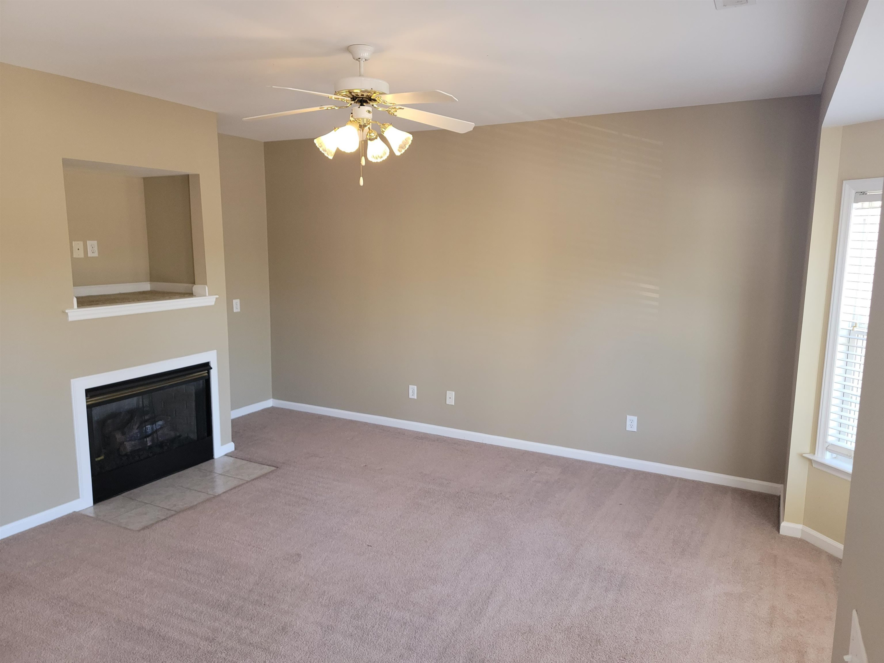 213 Dairy Road Clayton, NC 27520 - Photo 9 of 31 a view of an empty room with a fireplace