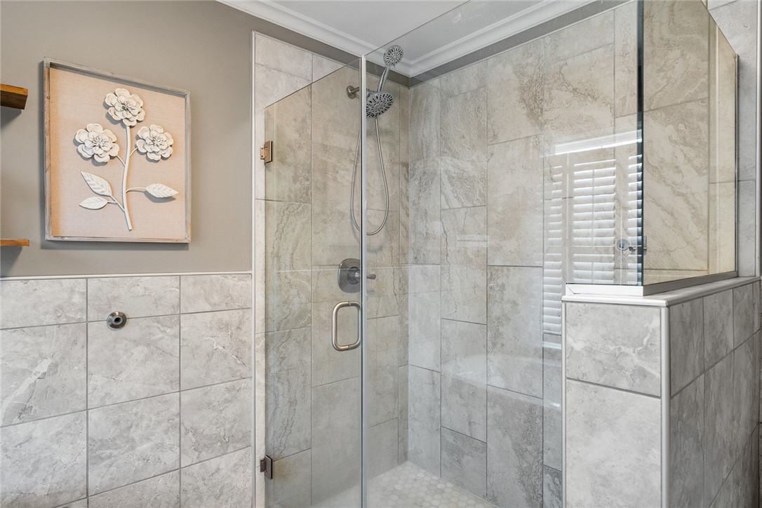 112 C-10-220 Anderson, SC 29621 - Photo 30 of 45 This modern bathroom features a tiled shower with a clear glass enclosure.