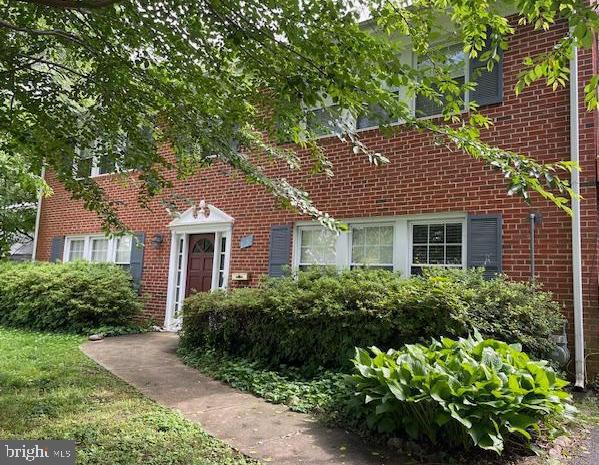 7121 Thrasher Road McLean, VA 22101 - Photo 3 of 4 a front view of a house with a yard