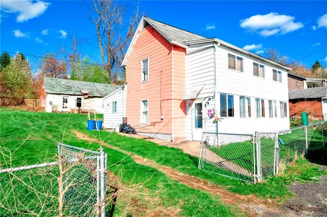 a view of house with backyard porch and sitting area