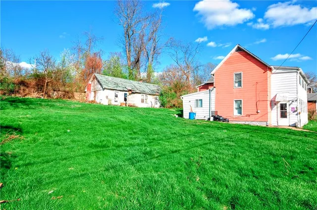a view of a house with a yard porch and sitting area