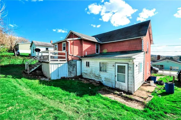 a view of a house with a yard and deck