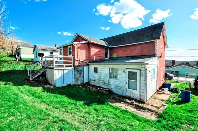 a view of a house with a yard and deck