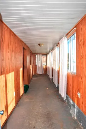 a view of a porch with wooden floor and stairs