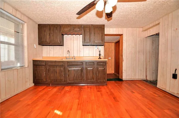a kitchen with stainless steel appliances granite countertop a sink dishwasher a refrigerator and wooden cabinets
