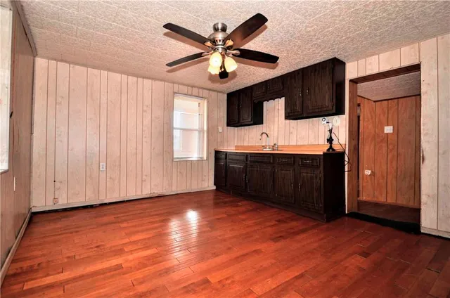 a view of open kitchen with wooden floor and cabinet
