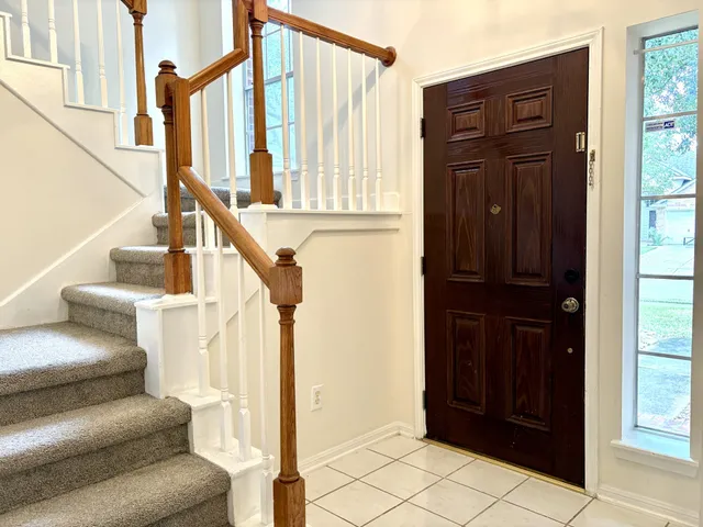 a view of entryway with wooden floor and stairs