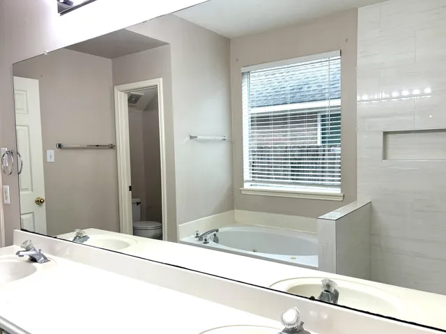 a bathroom with a tub and a sink