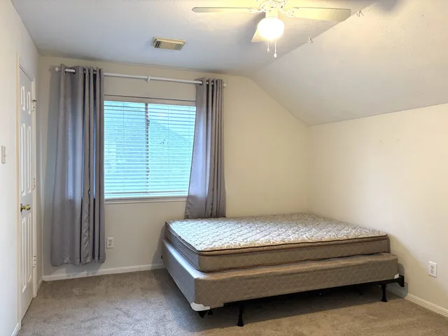 a bedroom with a bed and window