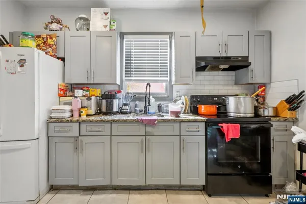 a kitchen with a sink cabinets and appliances