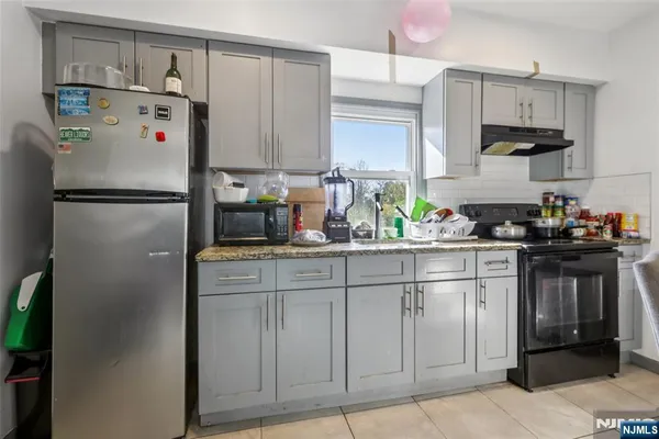 a white refrigerator freezer sitting in a kitchen